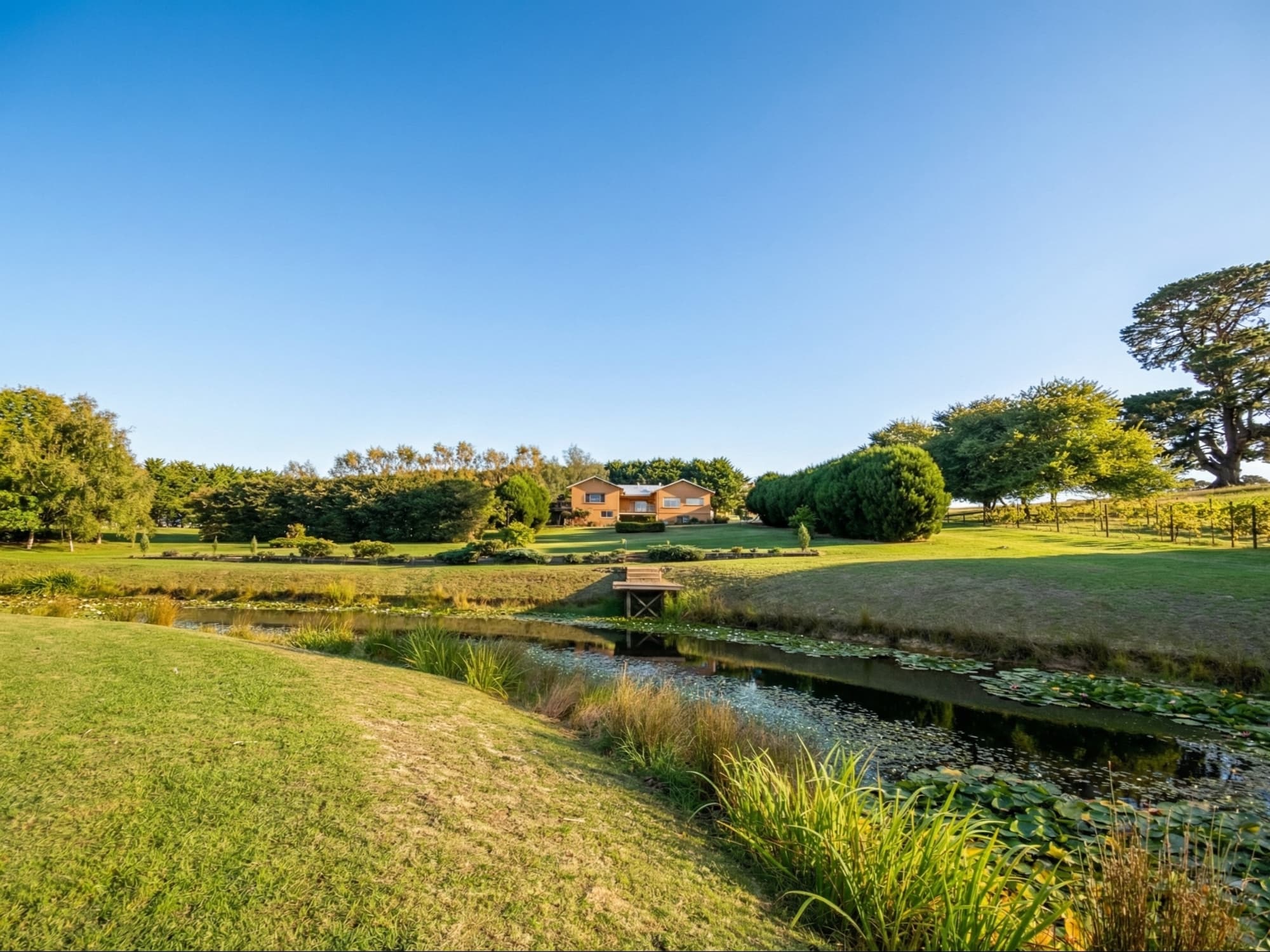 Broad view across the dam toward the main residence and outbuilding at 30 O'Malleys Rd, Mardan