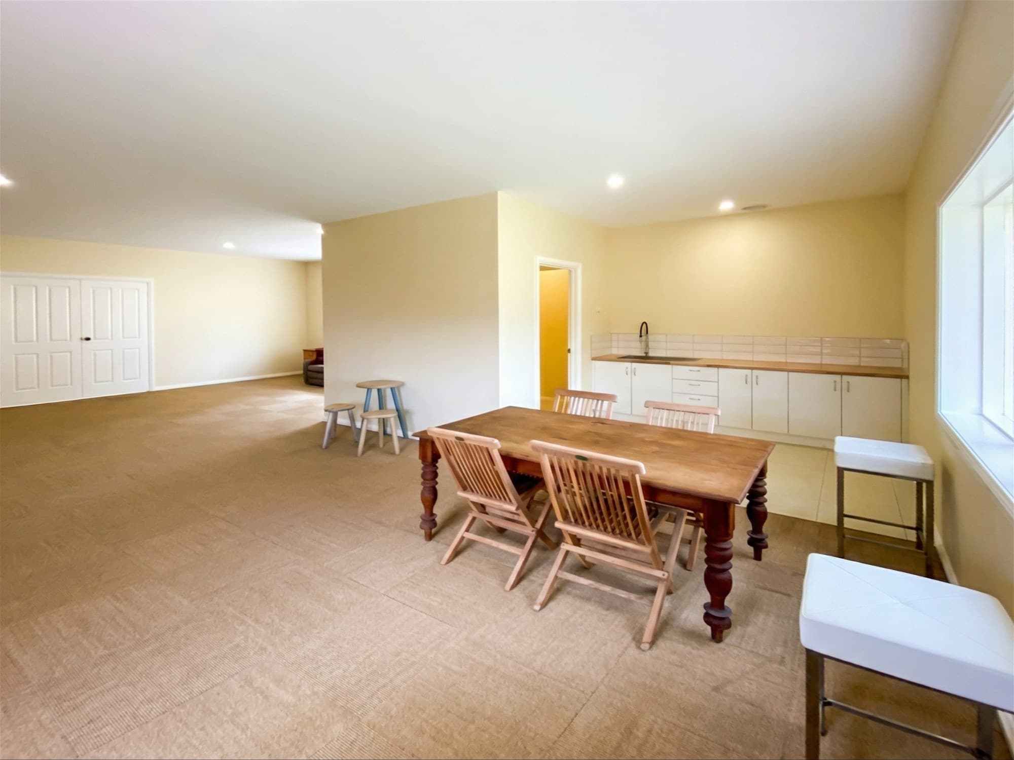 Flexible lower-level kitchenette and guest space at the active Mardan listing used as a contrast to a smaller beach-market search