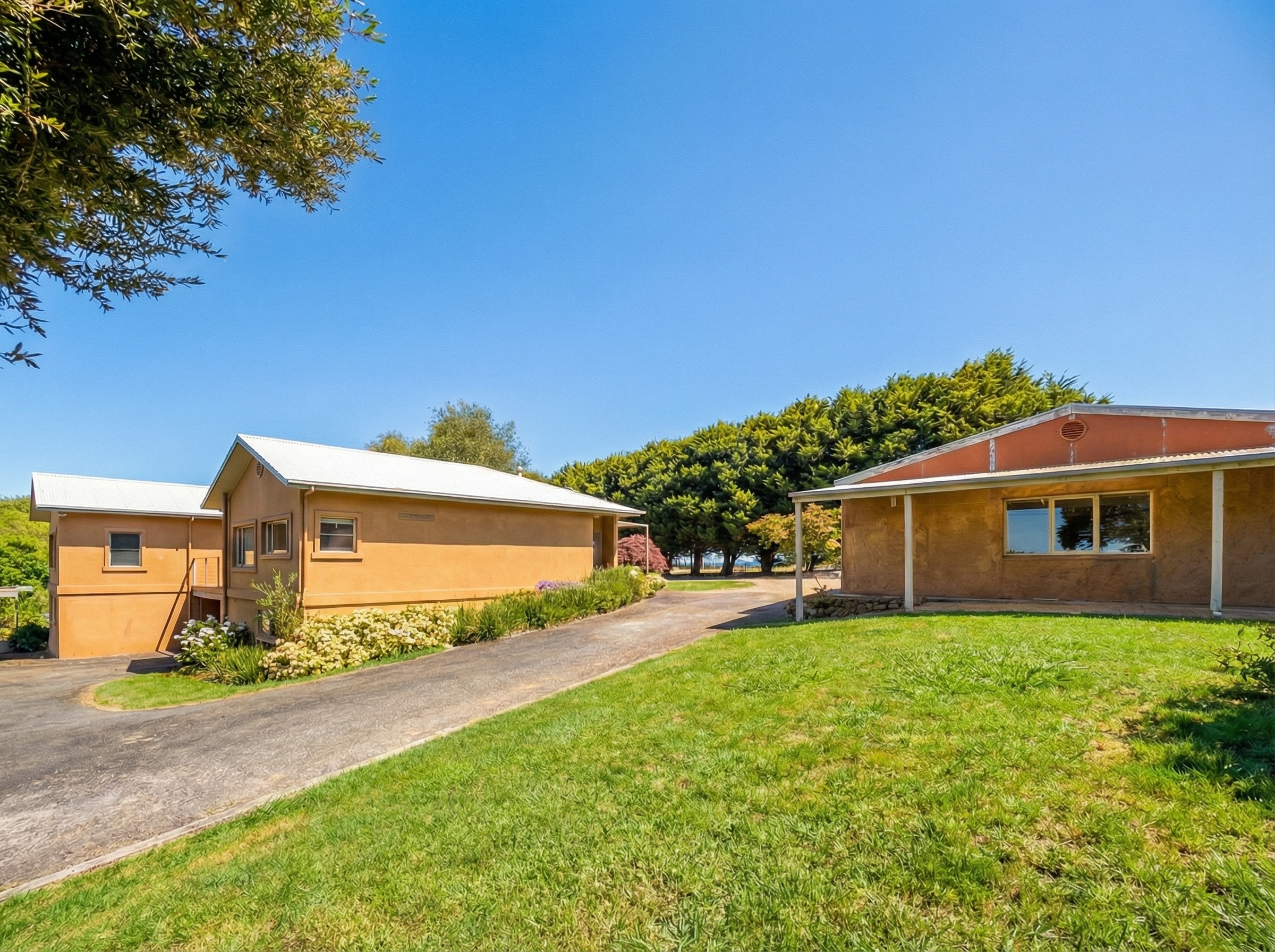 Main residence with poured earth studio and garages at Springbank